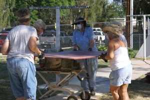 An all female crew cutting batten strips on the table saw.