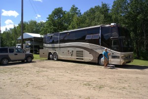 Our coach and car parked by their Bluebird next to the forest.