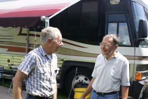 Larry (L) talking to Ed (R) in front of Ed's coach.