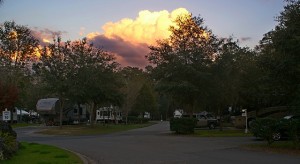 Sunset light on thunderstorm cloud to the east.  Our car and coach visible lower right.