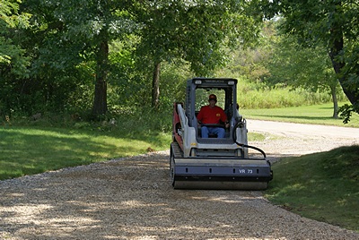 Rolling and compacting the driveway.