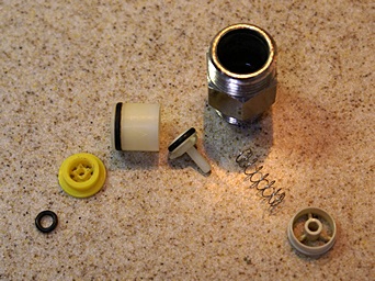 The disassembled kitchen faucet flow restrictor.