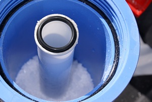 The salt retaining tube in the filter housing with salt around the bottom outside and the o-ring visible at the top.