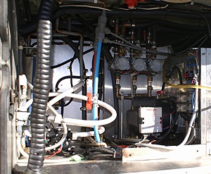 Cowling removed from Aqua-Hot revealing the burner and controller.