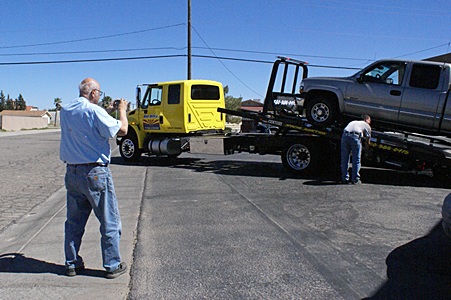 Lou photographs their pickup truck being loaded onto the flatbed hauler at the Circle K in Florence, AZ.