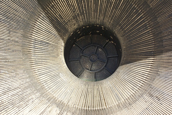 The exhaust nozzle of a Saturn V rocket engine.  It is more than wide enough for a person to stand up in it.