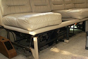 Forward end of passenger side sofa with end panel, footrest, table, and drawer removed. The footrest, table, and drawer were all motorized.