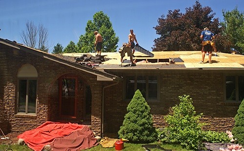 Installing soffit baffles and replacing roof decking on the front of the main roof.
