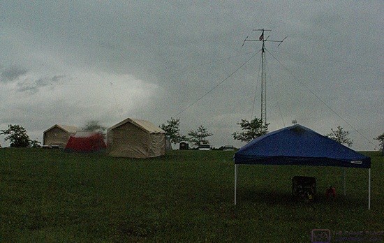 The ARRL FIeld Day event showcases the ability of amateur radio operators to set up equipment in the field on short notice and keep it on the air for 24 hours, no matter what. The weather turned bad for the event. The portable generator is under the tent in the right foreground.