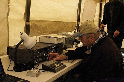 Jim (KC8WMW) stays dry as he works the GOTA (Get On The Air) station in one of the tents.