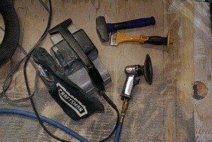 Floor prep tools: 4” belt sander, hammer and chisel, 4” rotary pneumatic body sander.