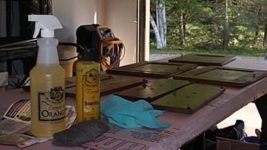 Foam insulation work surface in garage with walnut drawer fronts laid out for cleaning with Touch of Oranges.