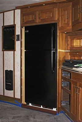 The pantry and refrigerator installed in the alcove.