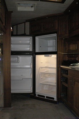 The new refrigerator in the alcove with the doors open.