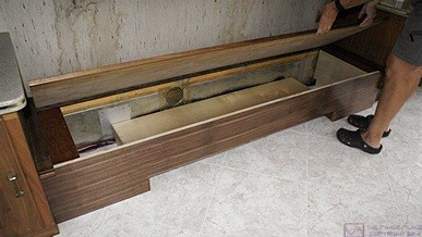 The built-in sofa with the plywood seat raised to reveal the plenum/support boxes on both ends and the center shelf that forms the air return duct for the OTR HVAC. The empty space will be used for storage.