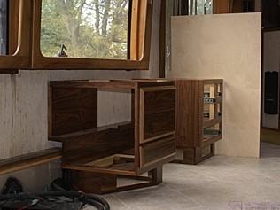 The main pieces of the desk set in place but not yet assembled or secured, and without the temporary plywood top or permanent Corian countertop.