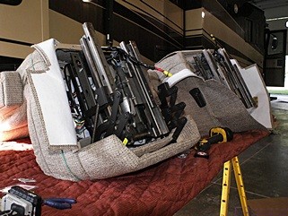 The old 6-way power bases being attached to the new Flexsteel pilot and navigator captains seats. The new seats came with new controls that Tyler had to mount and wire. Both seats also included lumbar support air bladders with their own air pump as part of the seat.