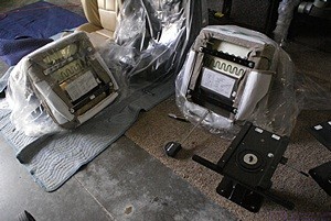 A view of the bottom of the two new Flexsteel “class C” captain’s chairs for the passenger side of the of the living room with one of the slide/swivel bases and its seatbelt attachment bar.