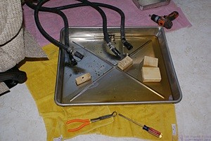 The coolant hoses with the heat exchangers removed. We were able to contain the coolant in the tray and not get any on the new floor tiles.