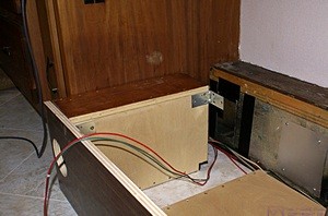 The left support/plenum box with the circular register hole cut in the face plate.