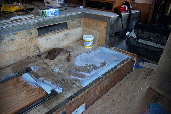 Floor patching compound being applied to the co-pilot/navigator platform.