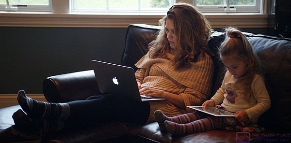 Like mother, like daughter; Shawna takes care of some work tasks on her laptop while Madeline shows equal attention to detail on the iPad.