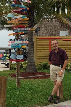 Bruce by the signposts at the Charlotte Harbor Sheraton Four Points Hotel, Punta Gorda, FL.