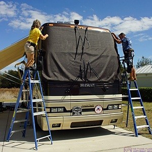Brenda and Bill test fit the main windshield cover before installing the corner snaps on our Prevost H3-40 motorcoach. Site #230, Florida Grande Motorcoach Resort, Webster, FL.